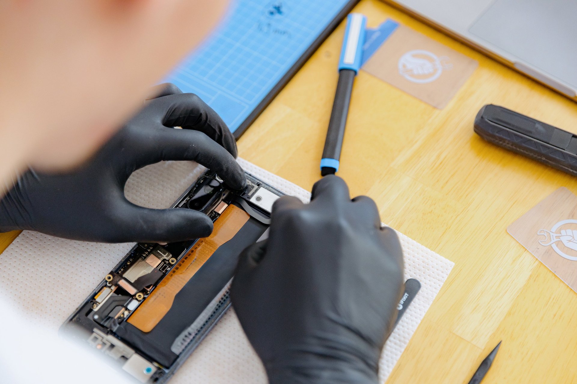 One young handsome Caucasian man repairing a smartphone